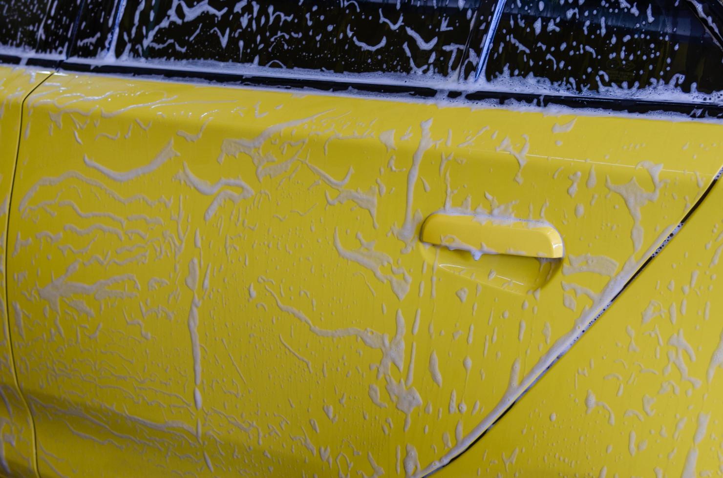 Yellow car getting washed photo