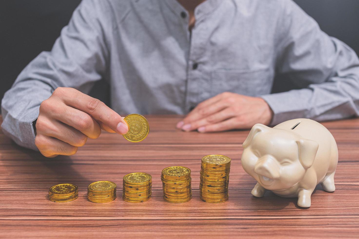 Man and stacked coins photo