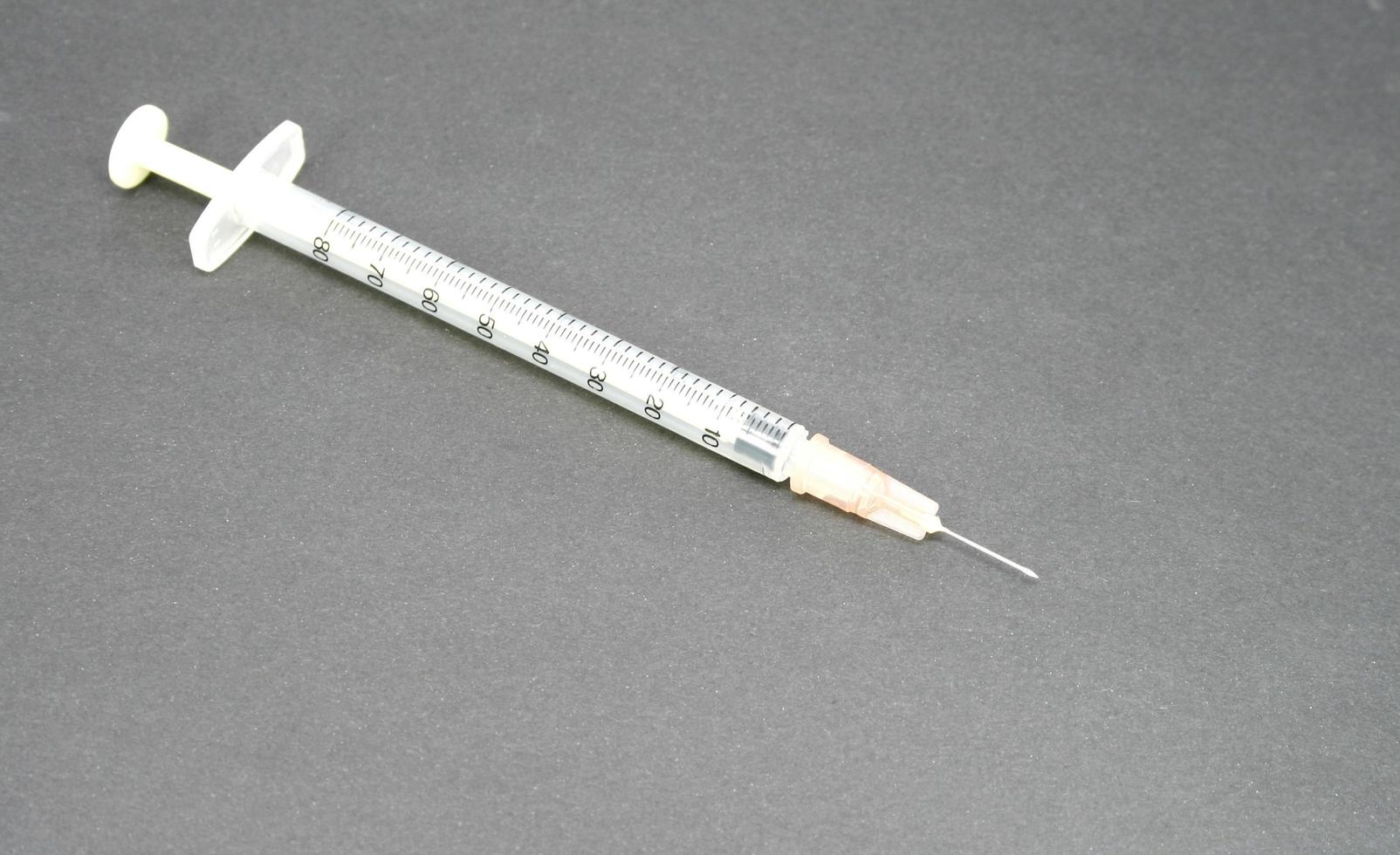 hypodermic syringe on black photo