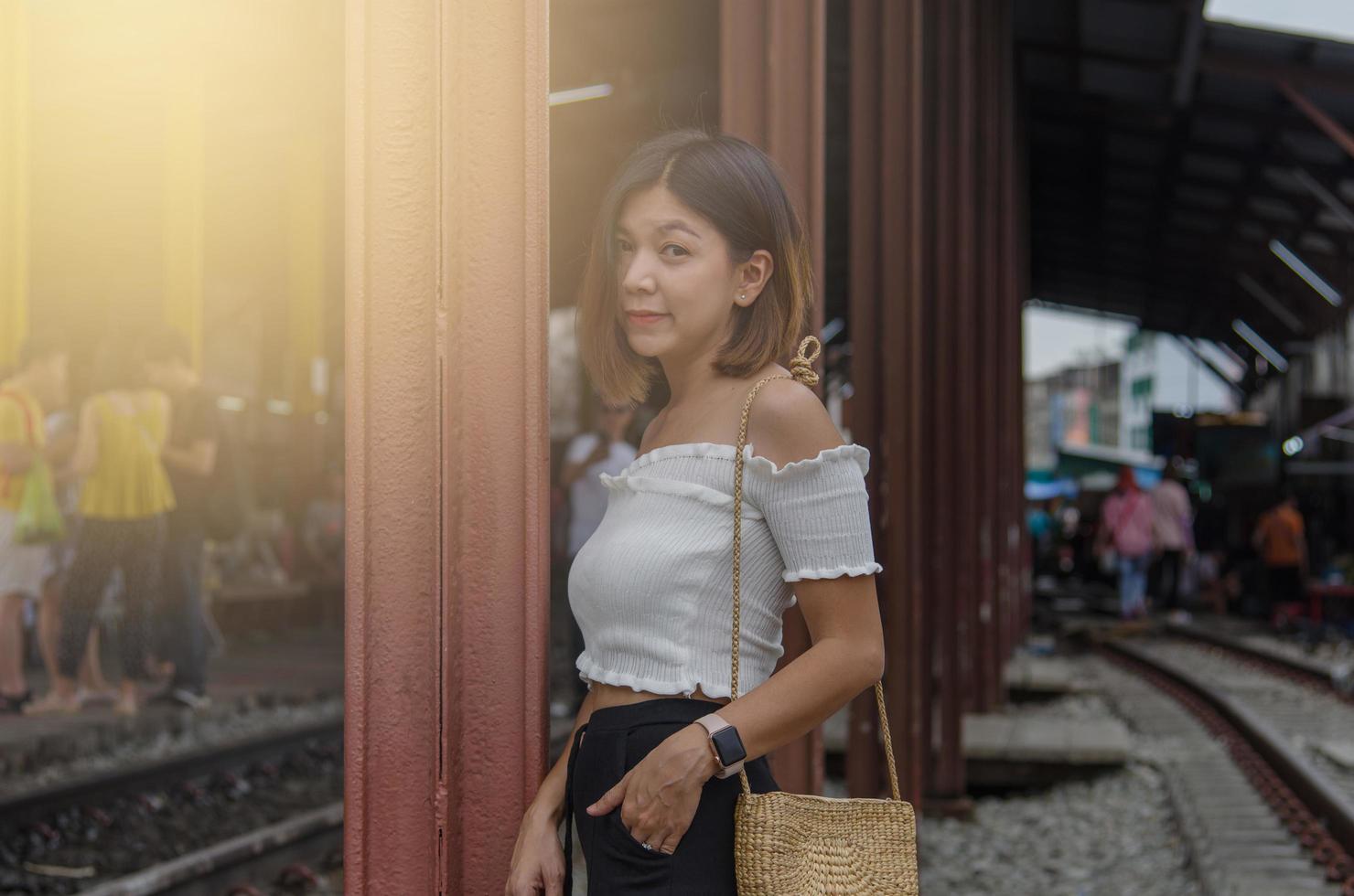 Asian woman posing on the train tracks photo