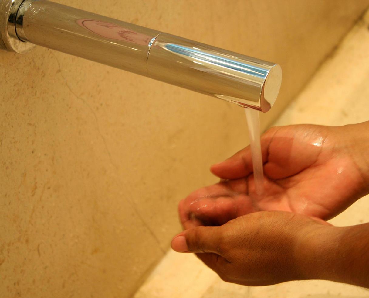 Washing his hands at the tap photo