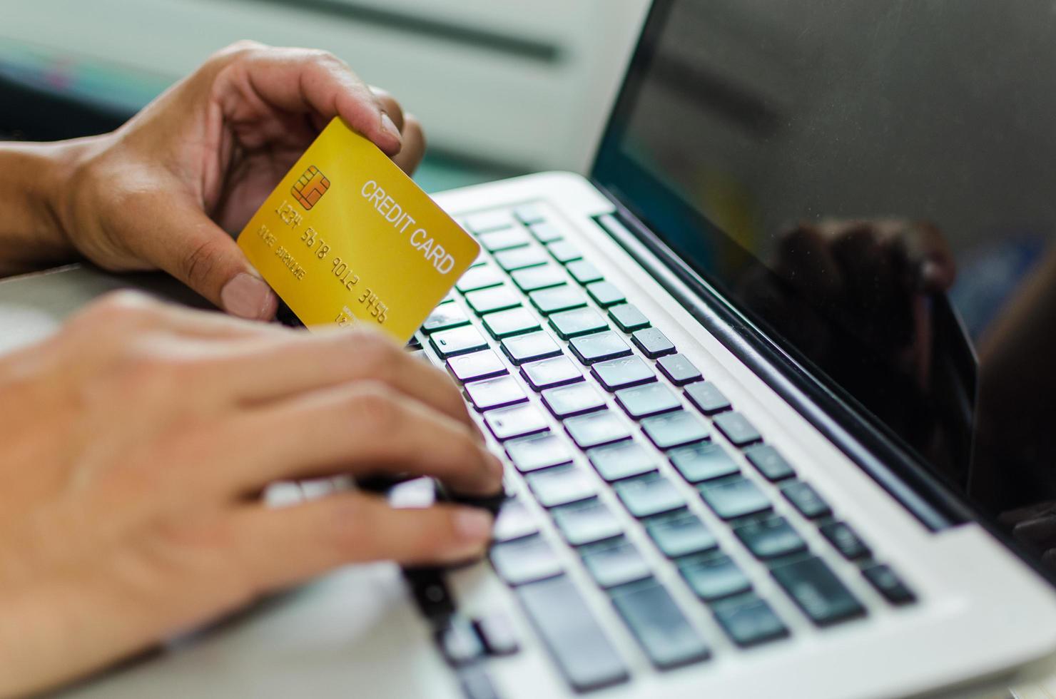 Person using credit card to shop online photo