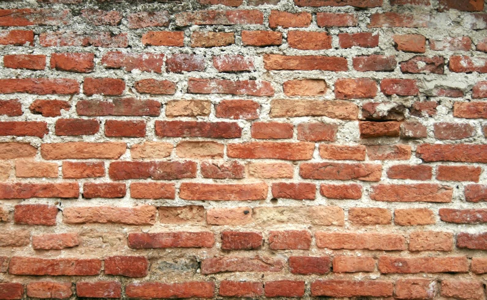 Worn red brick wall photo