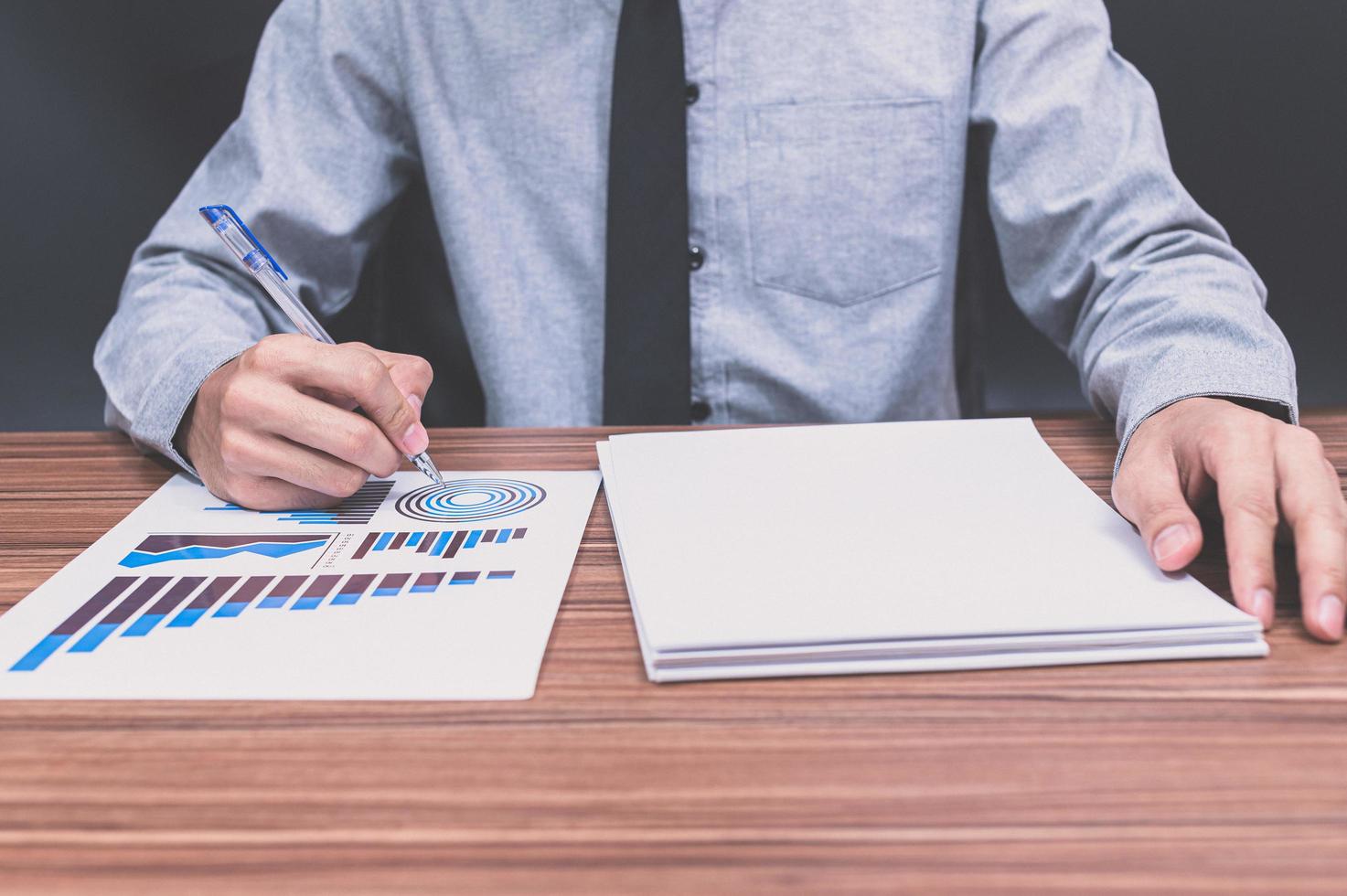 Businessman examining business financial document photo