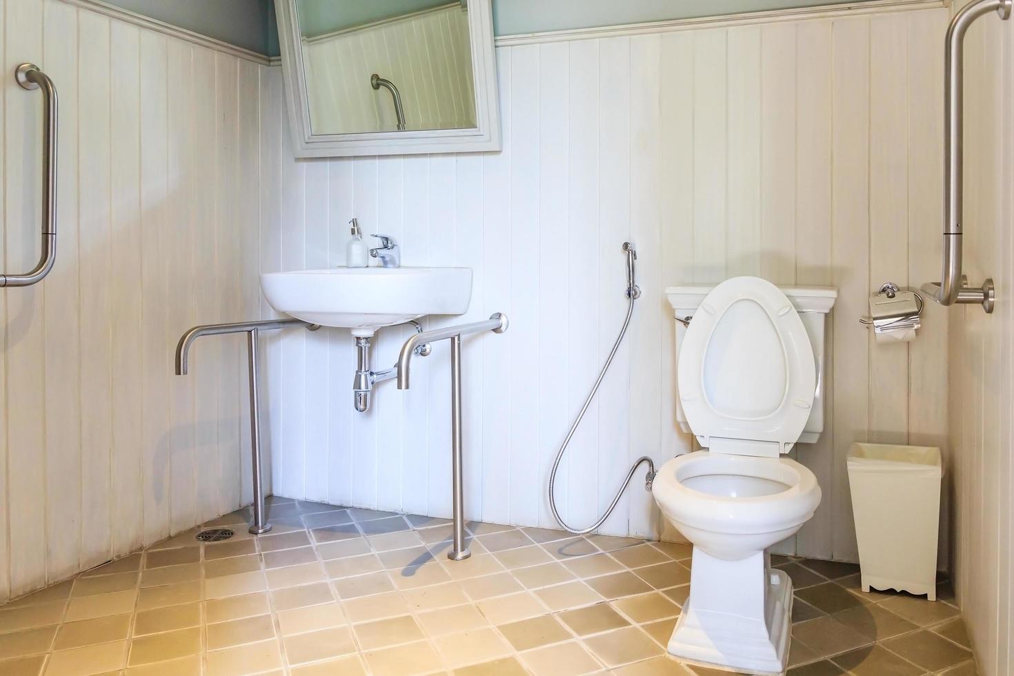 Toilet and sink with handrails photo