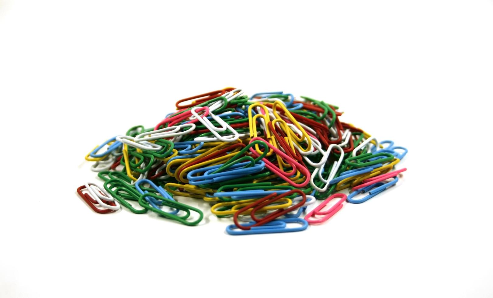 Colorful paperclips on white photo