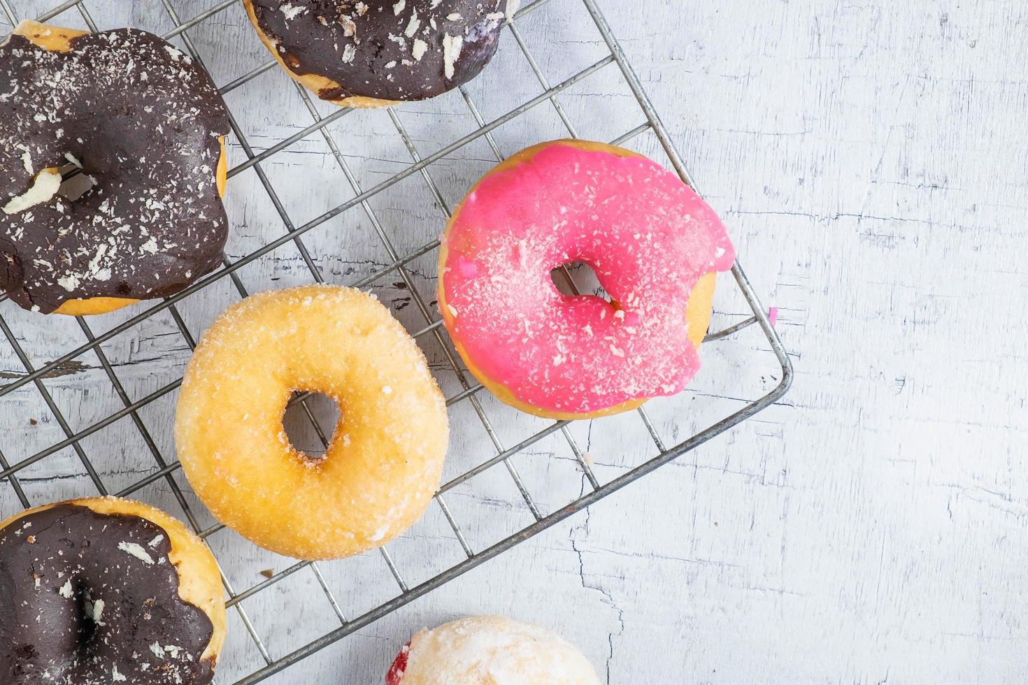 Pink donut with other donuts photo