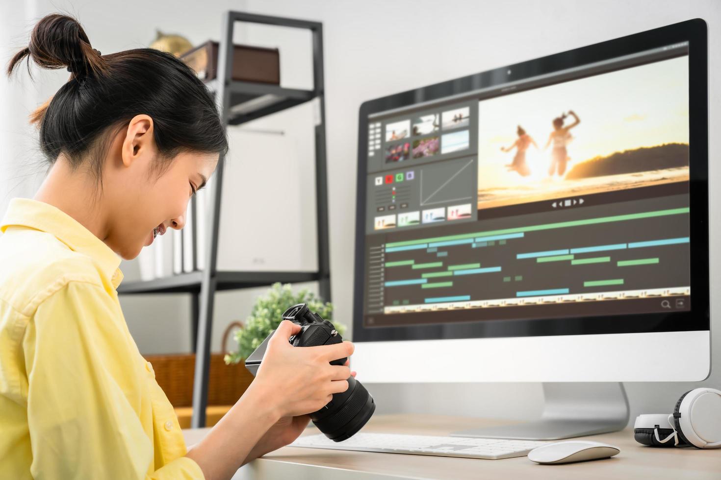 Woman holding a camera and using application photo