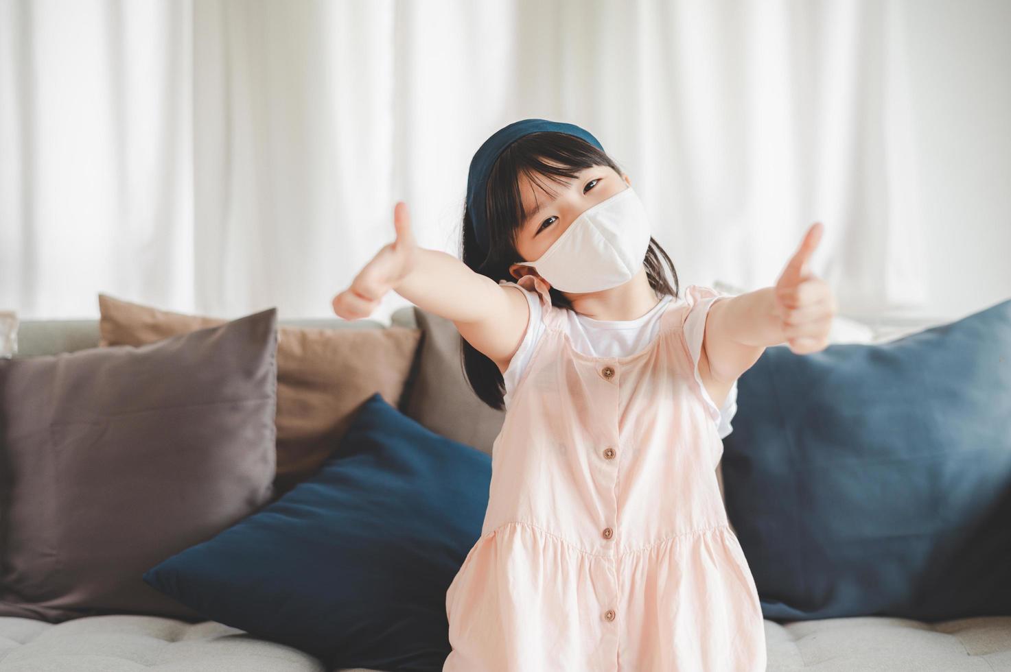 Give giving thumbs up while wearing mask photo