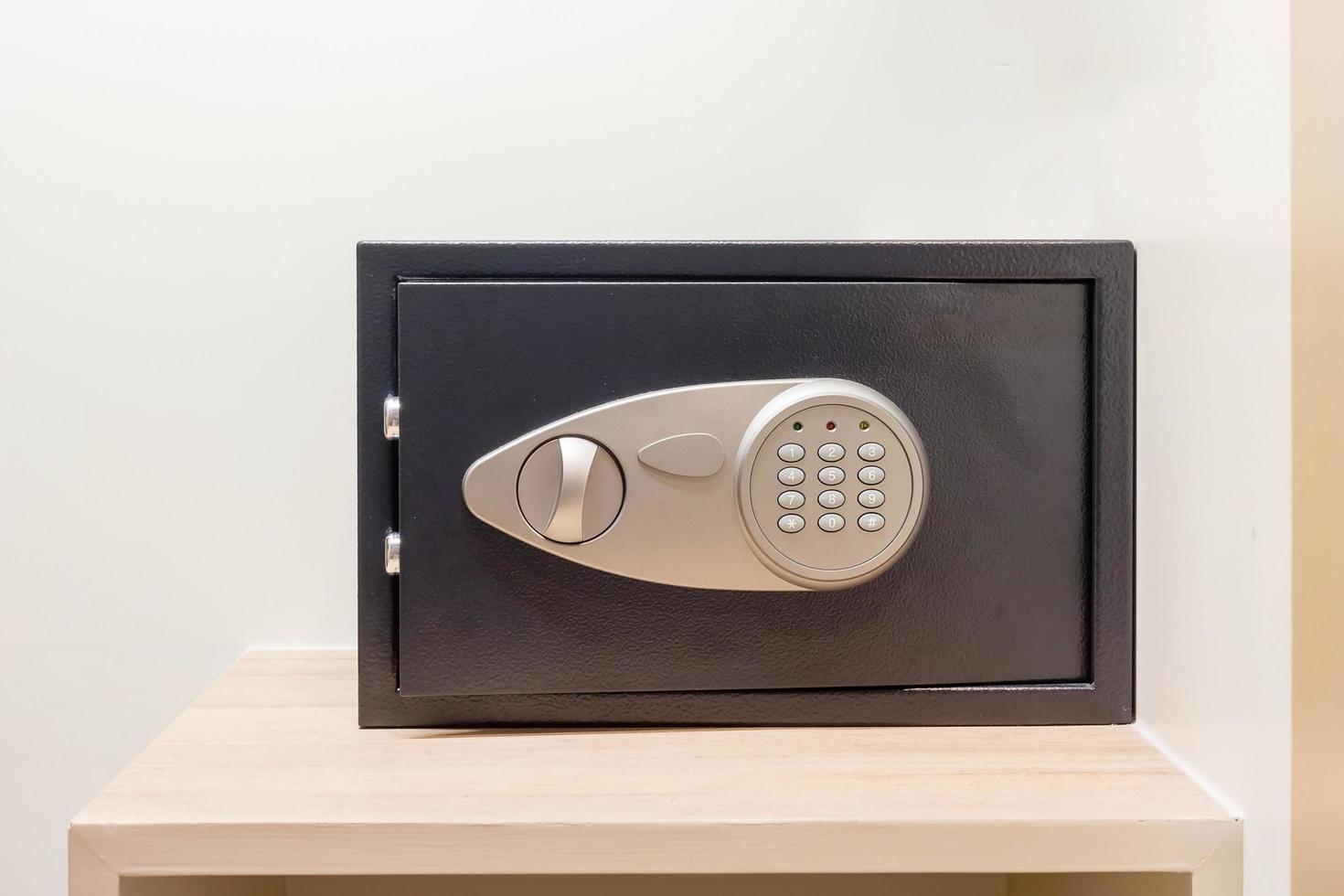 Safe box with electronic lock hidden in the wardrobe at the hotel. photo