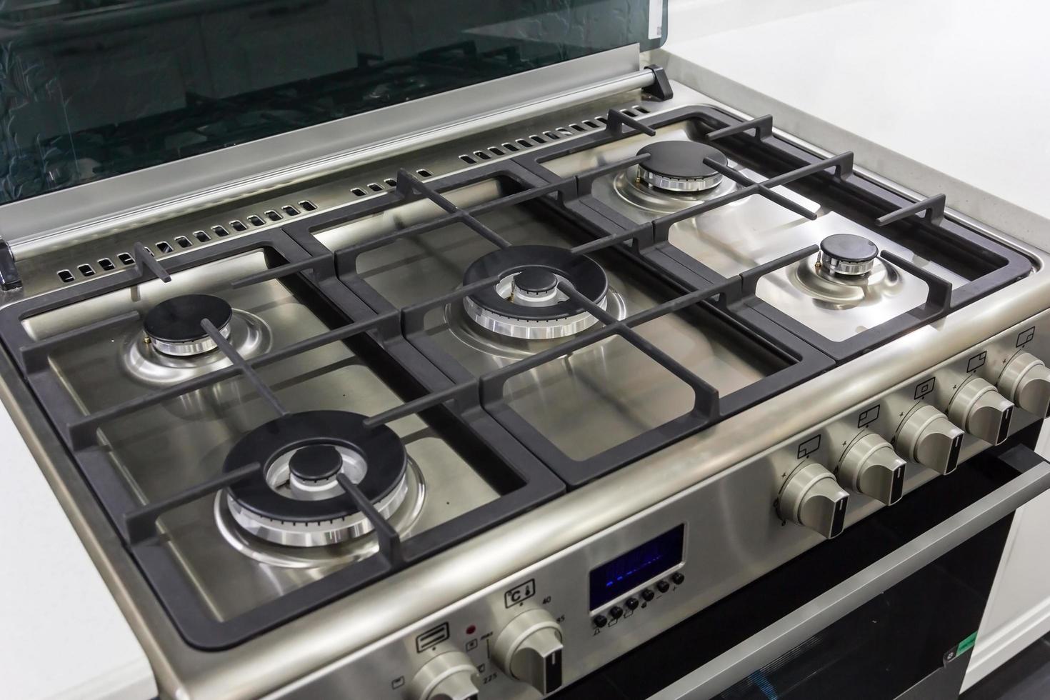 closeup of brand new, modern gas stove on countertop in contemporary modern home kitchen. photo