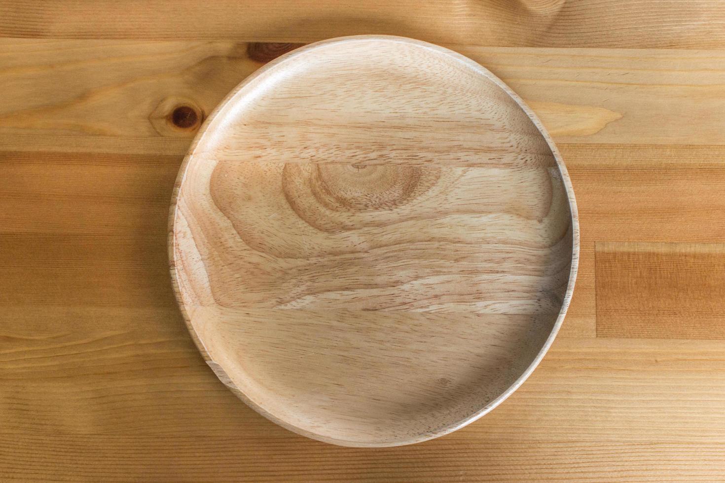 Wooden plate on wood table photo