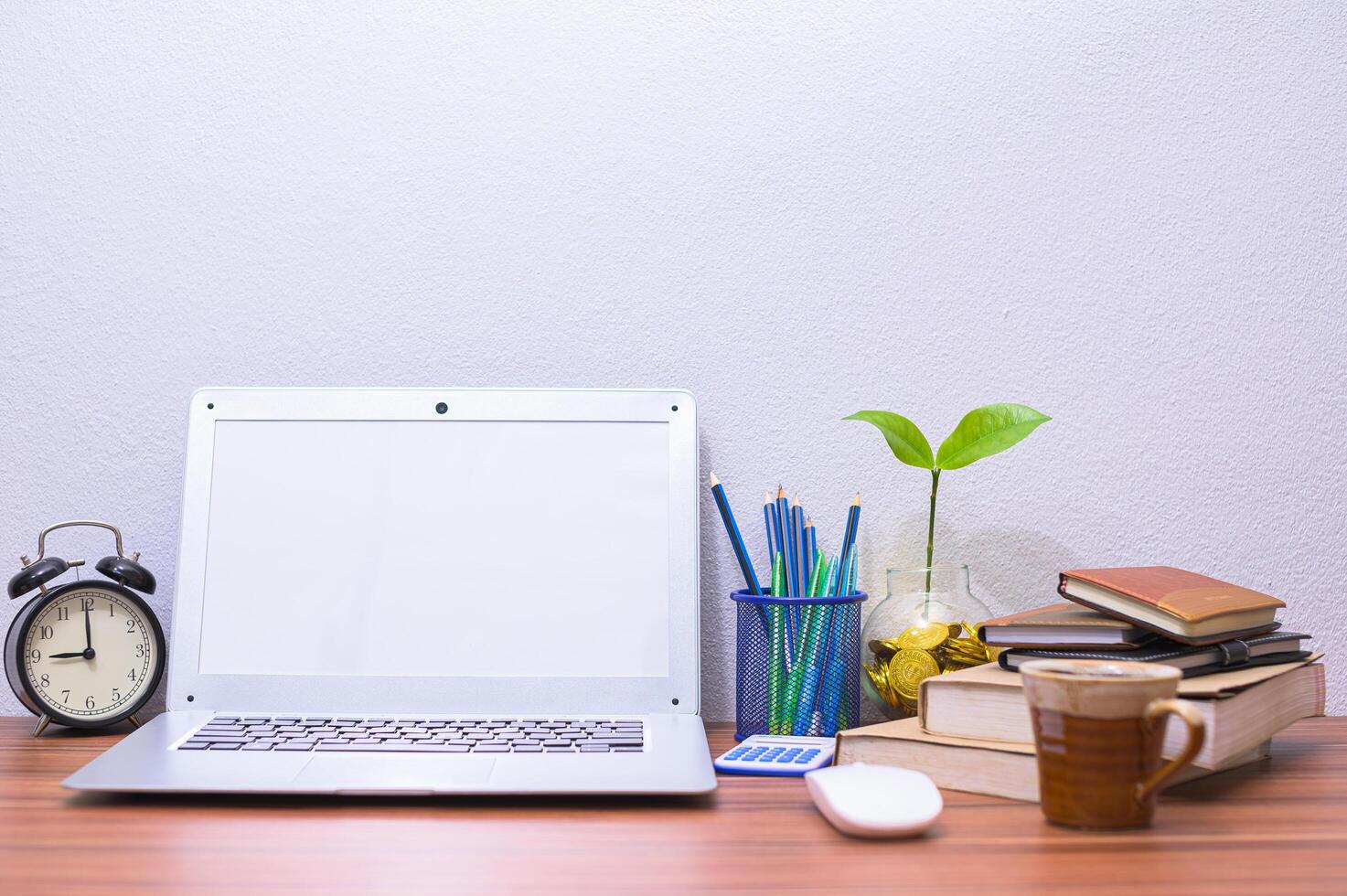 Laptop and other objects on the desk photo