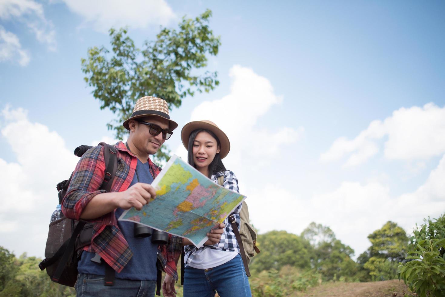 Happy young hikers standing in the forest photo