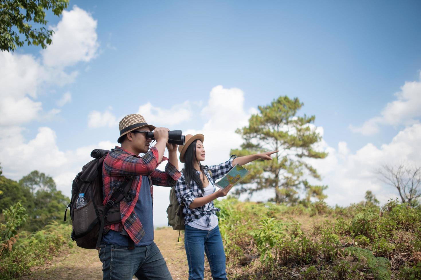 Happy young hikers standing in the forest photo