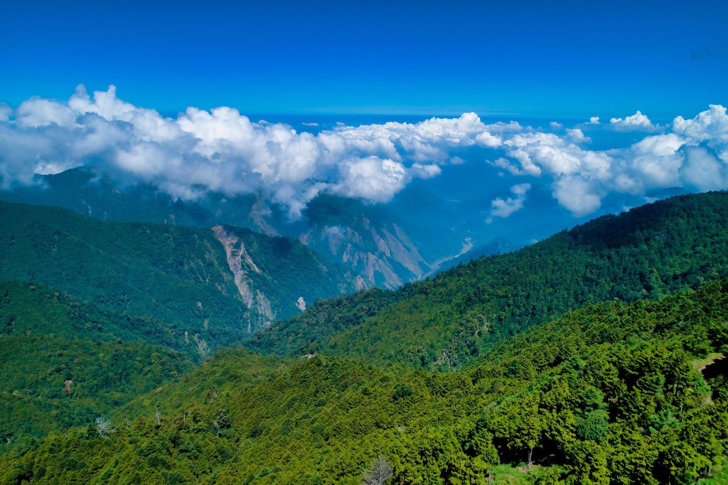 Clouds over green mountains photo