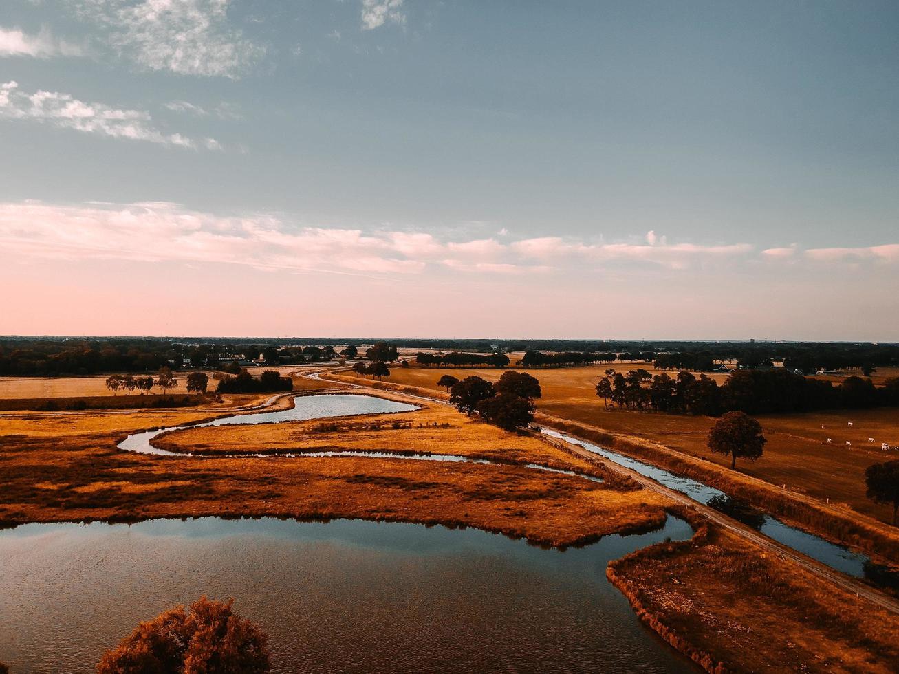 Aerial view of land with stream photo