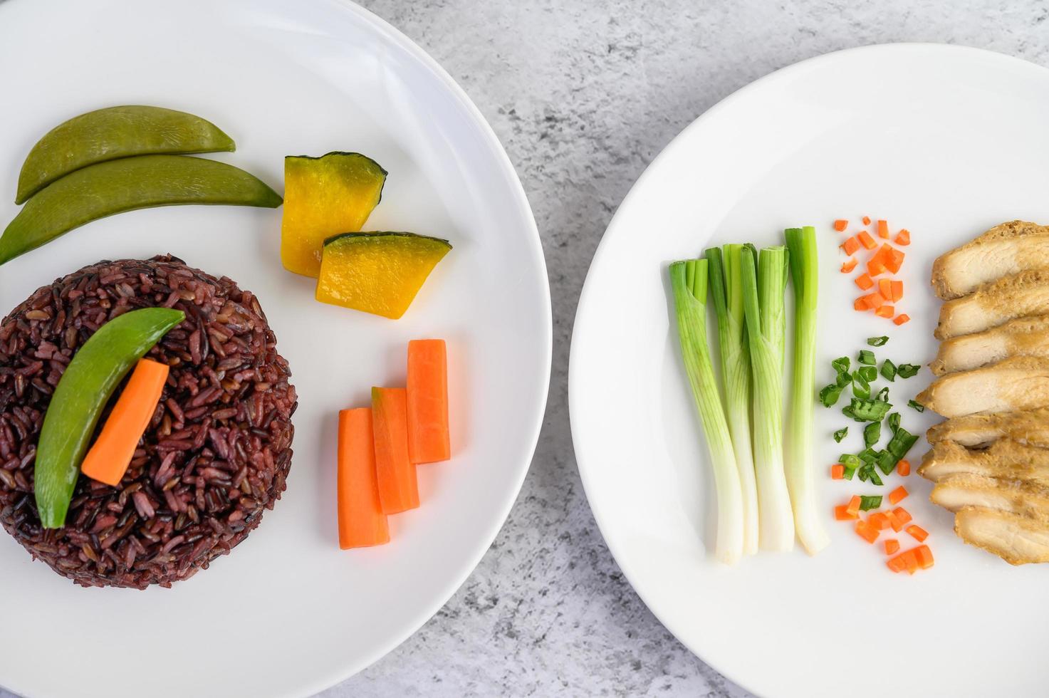 Black rice with pumpkin, peas, carrots, baby corn and steamed chicken breast photo