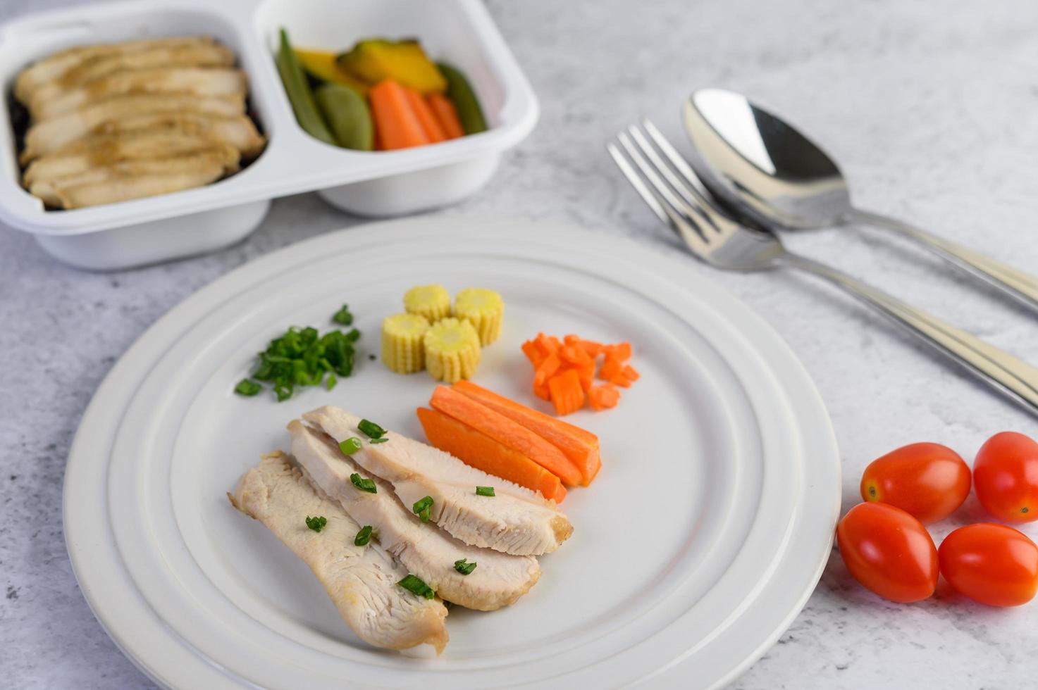 Steamed chicken breast with spring onions and chopped carrots photo