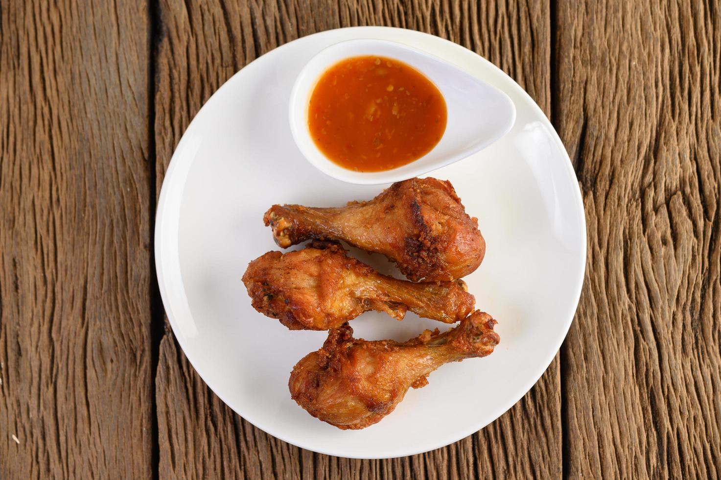 Fried chicken legs with sauce photo