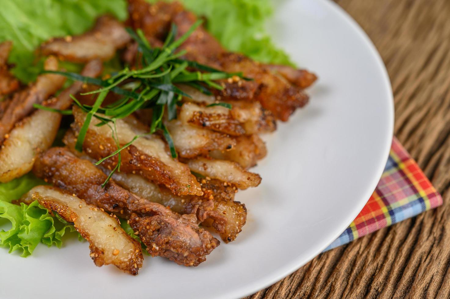 Grilled pork neck on a wooden table photo