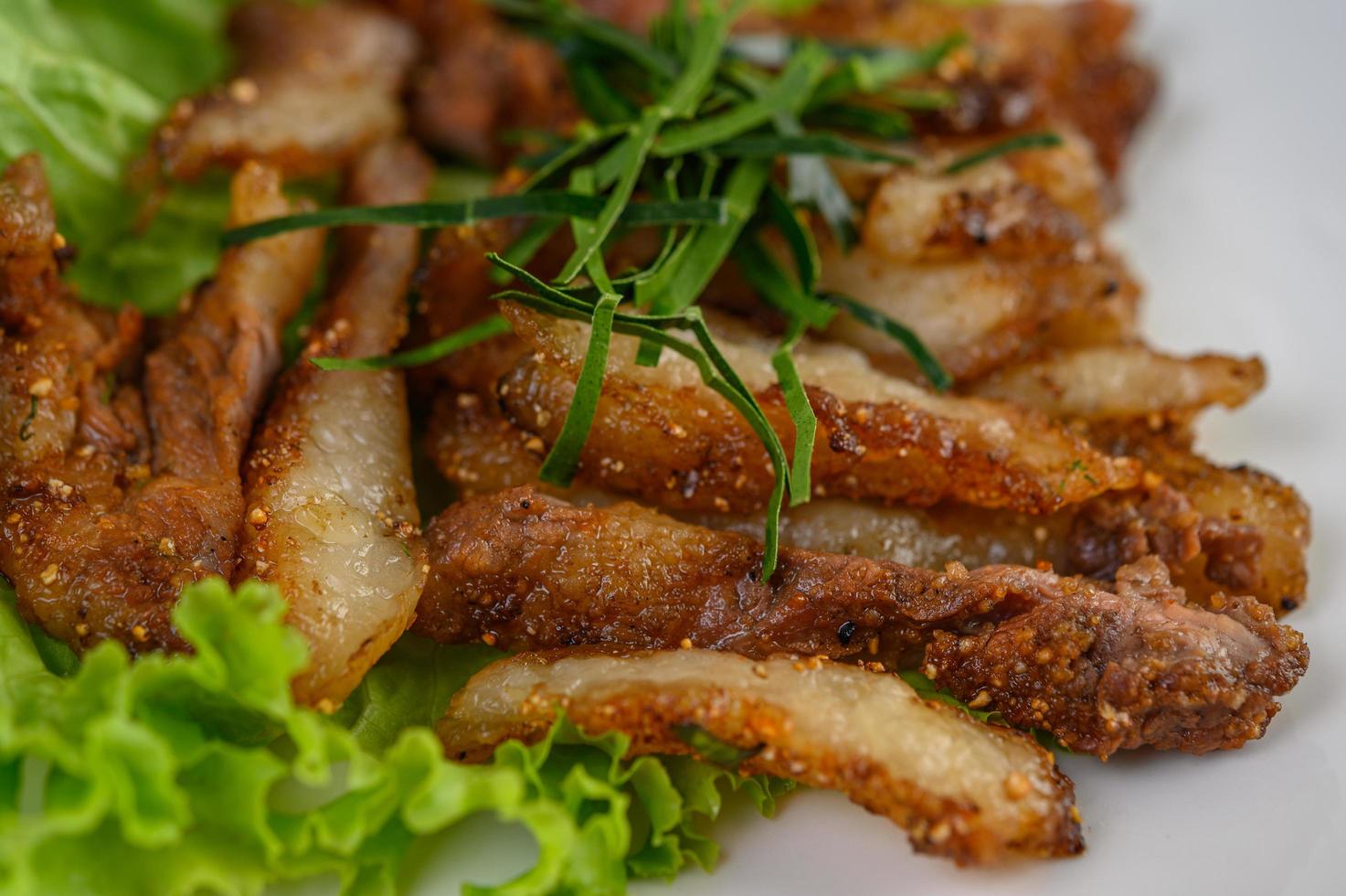 Grilled pork neck on a wooden table photo