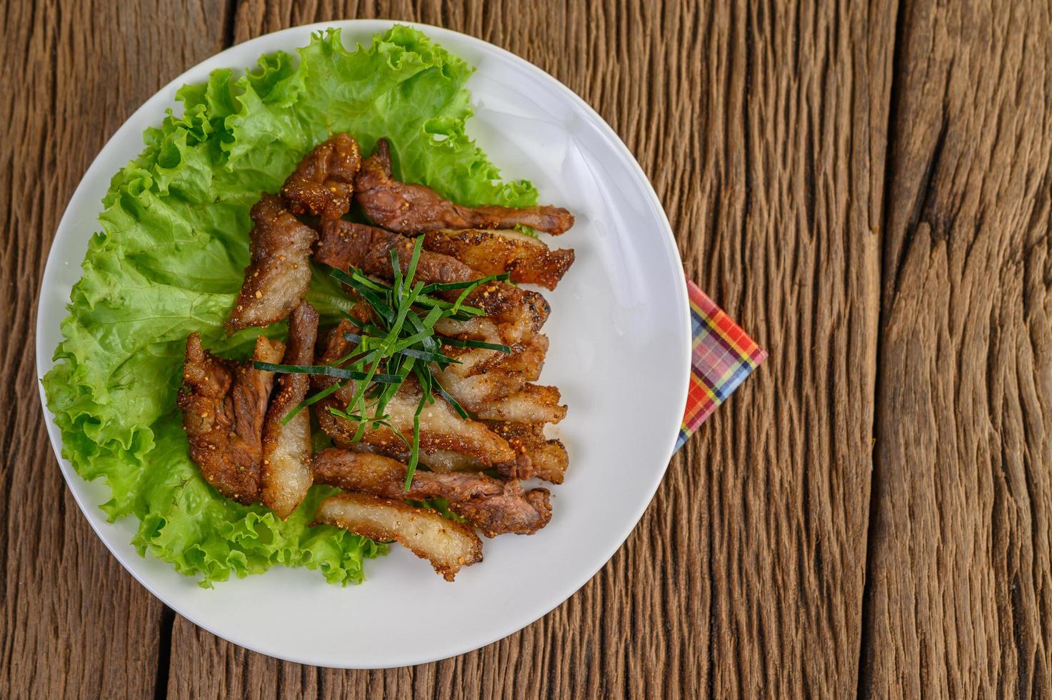 Grilled pork neck on a wooden table photo