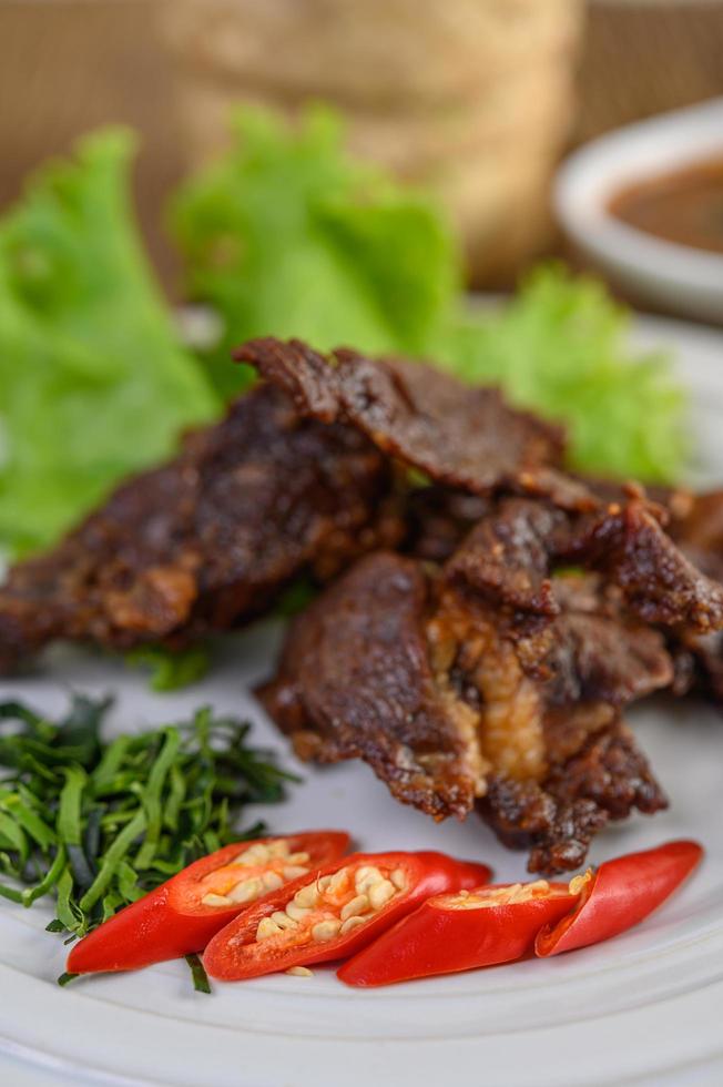 Beef fried Thai food with spring onion, lime, chili and salad photo
