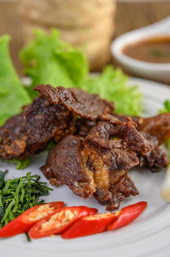 Beef fried Thai food with spring onion, lime, chili and salad photo