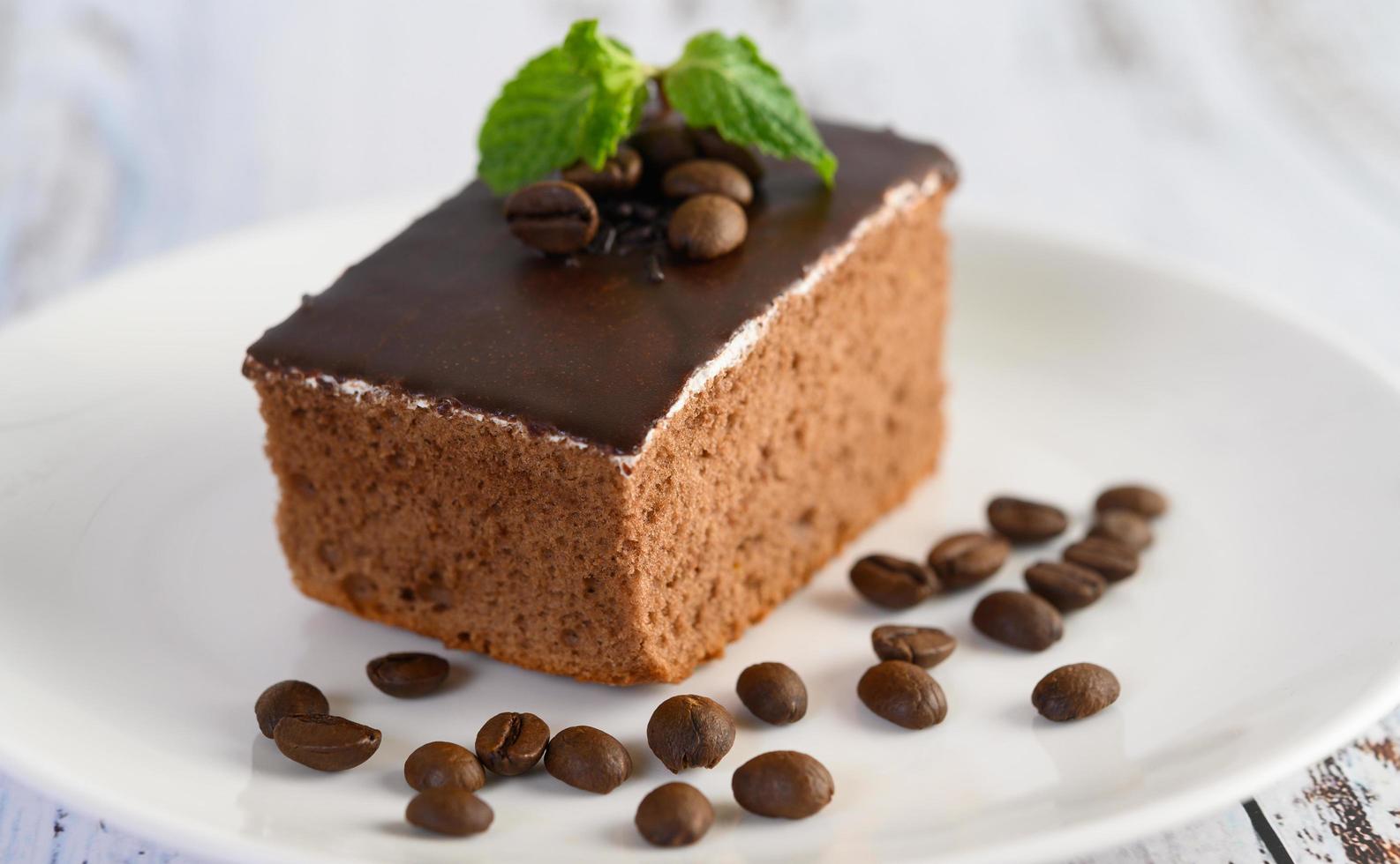 Chocolate cake with coffee beans on a wooden surface photo