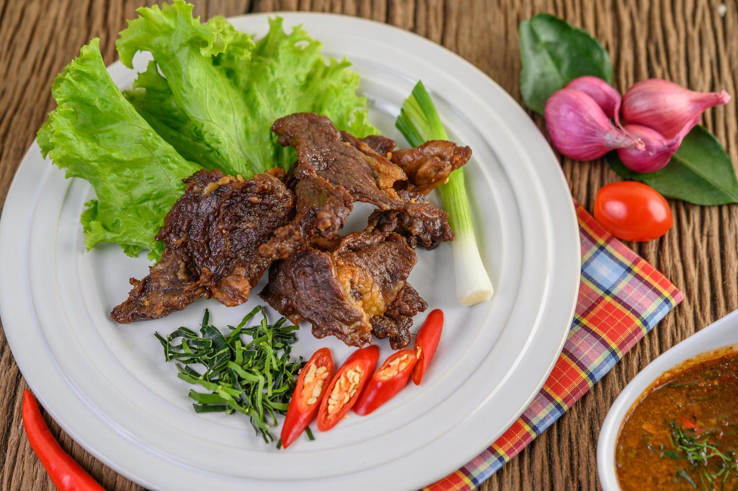 Beef fried Thai food on wooden table photo