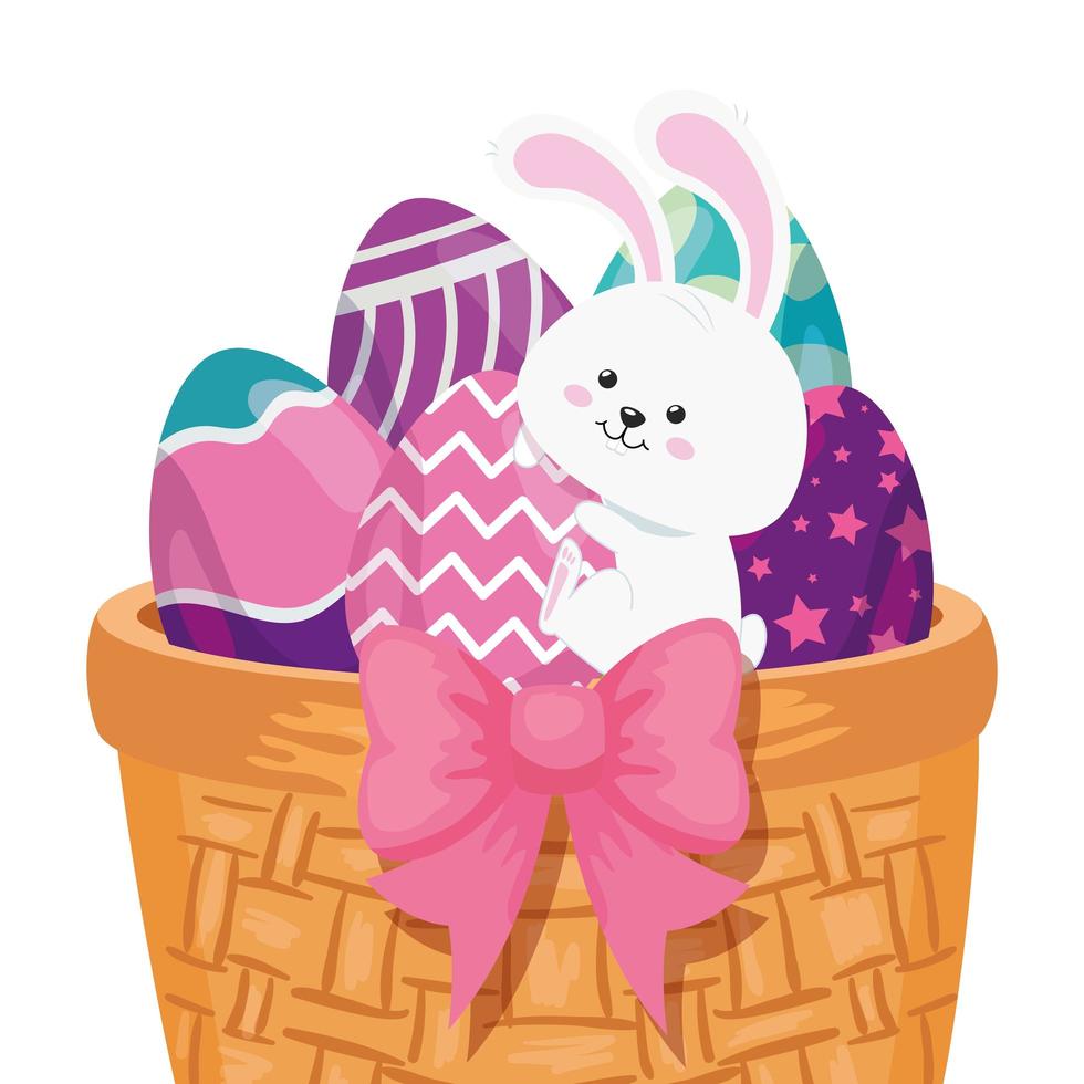 Conejo y lindos huevos de pascua decorados en canasta de mimbre vector