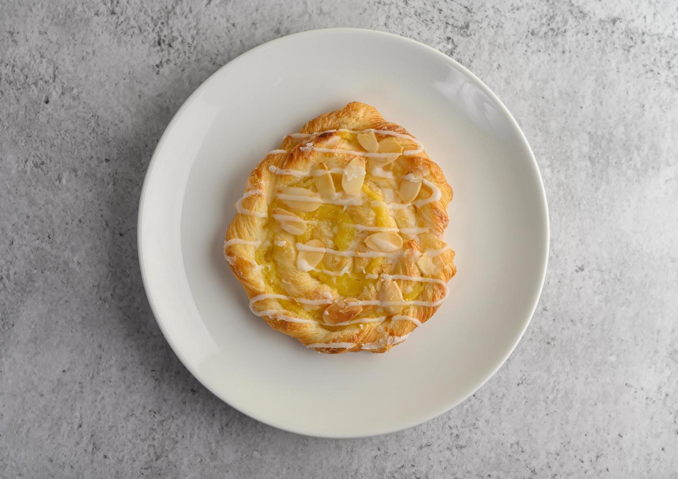 Almond twist bread snack on a white plate photo