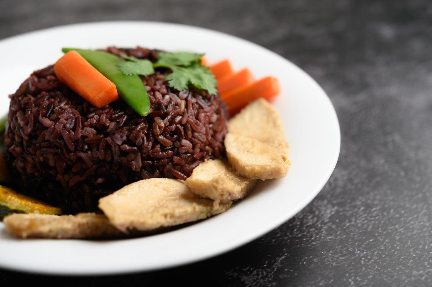 Purple rice berries with grilled chicken breast, pumpkin, carrots and mint photo