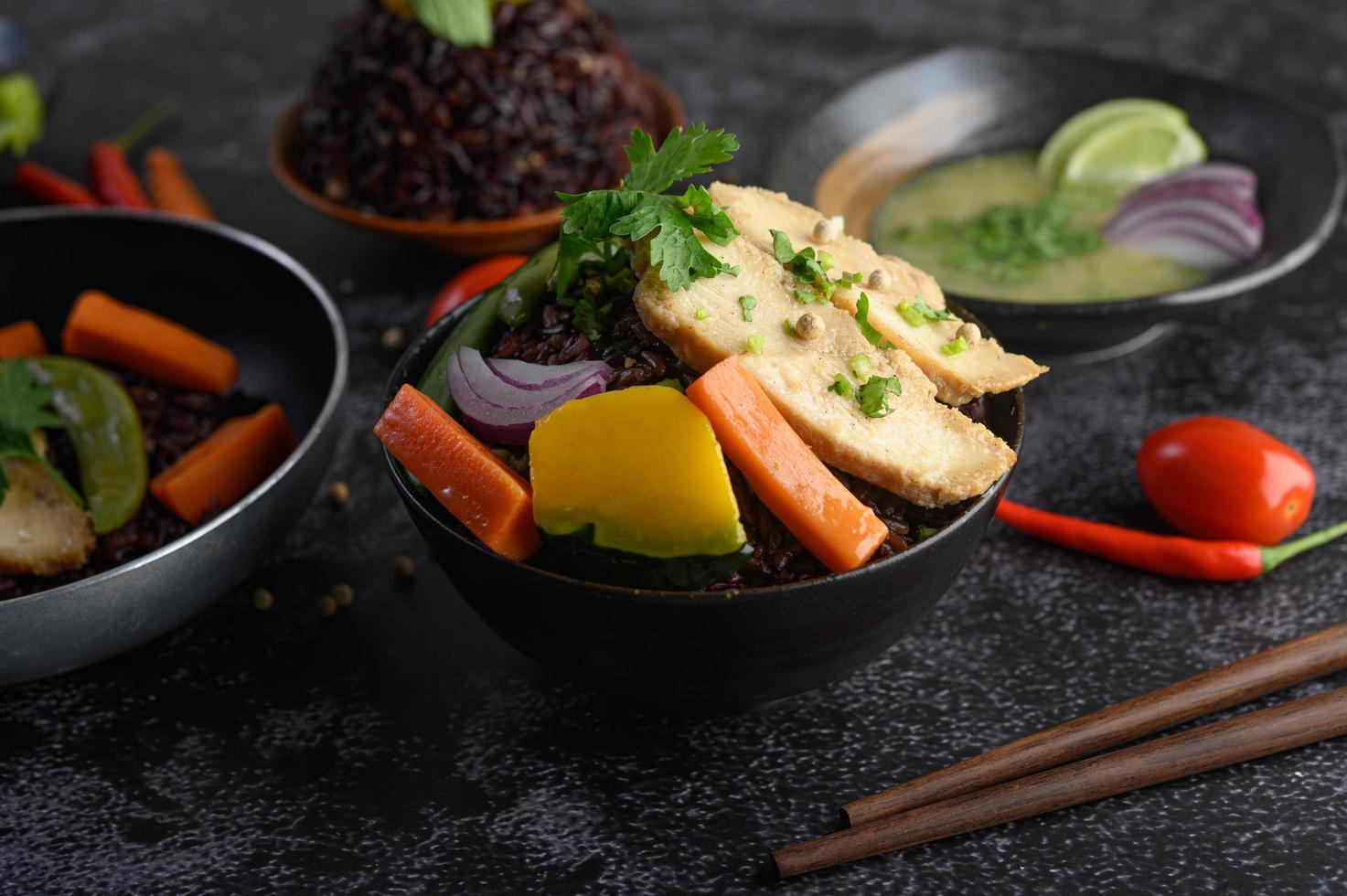 Purple rice berries with grilled chicken breast, pumpkin, carrots and mint photo