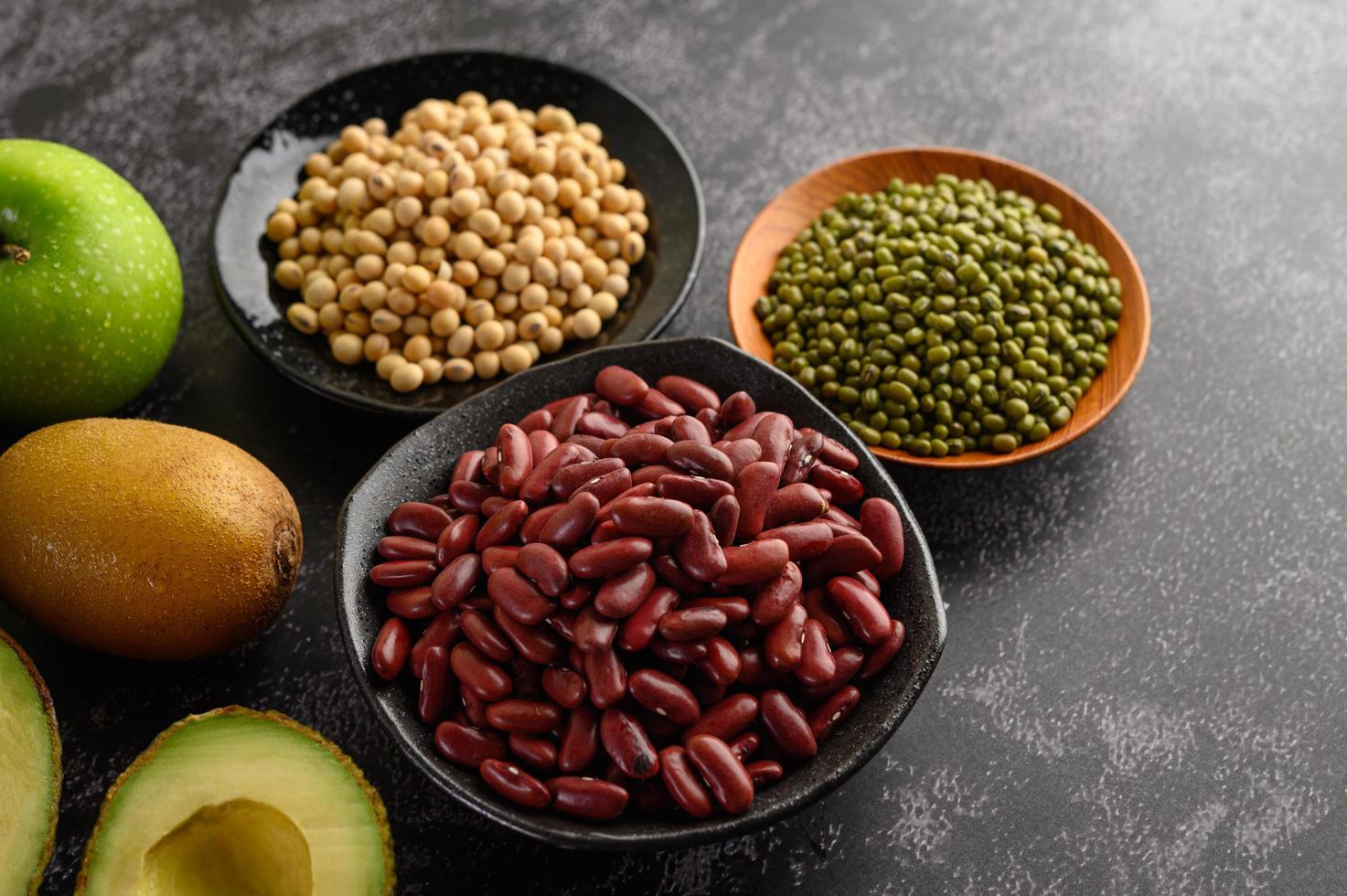 Legumes and fruit on a dark background photo