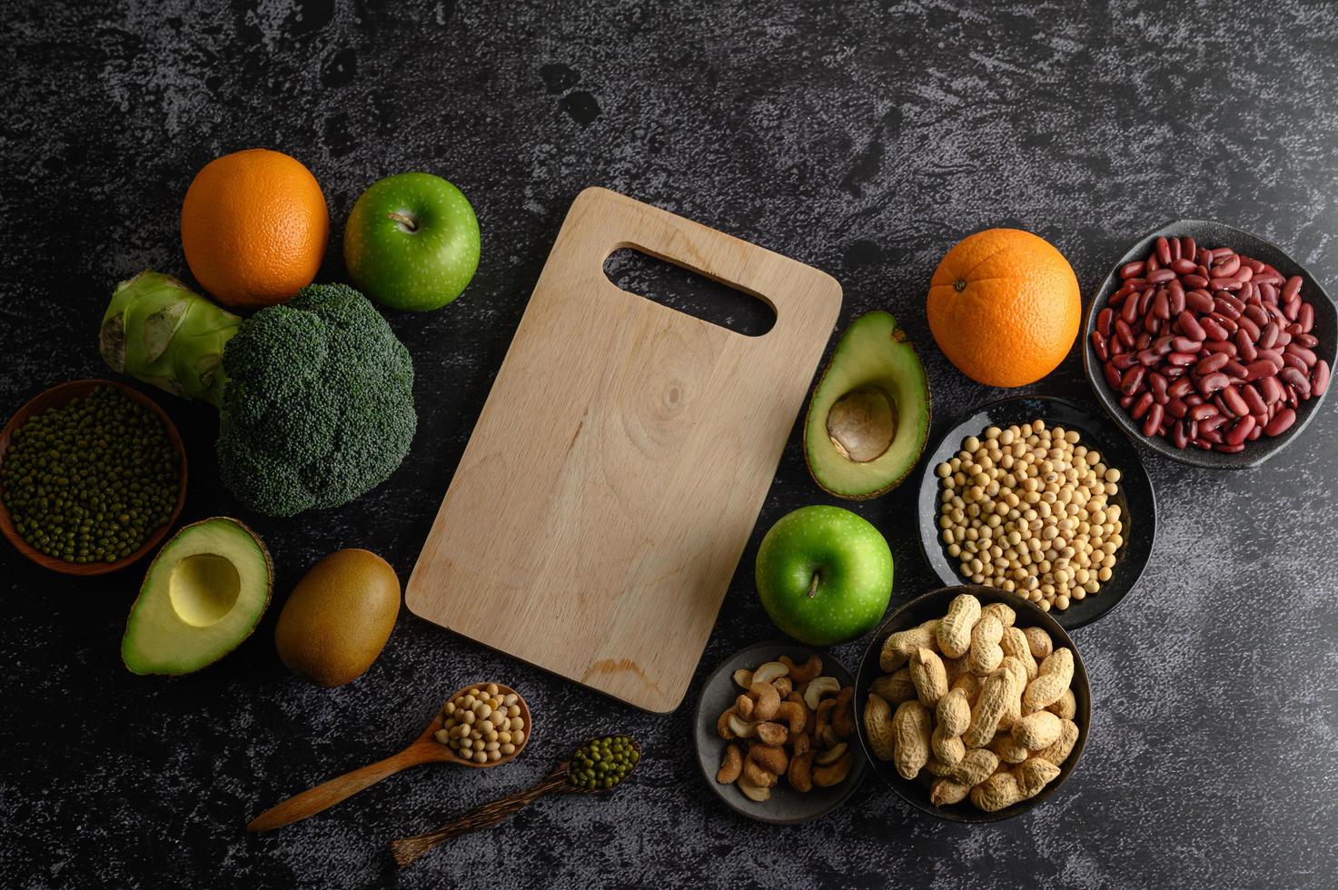 Legumes and fruit on a dark background photo