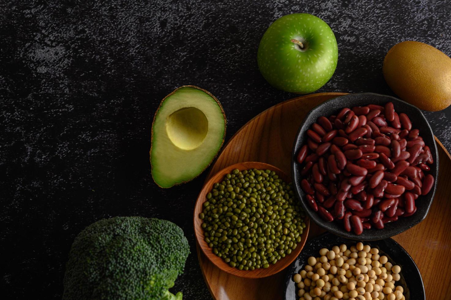 Legumes and fruit on a dark background photo