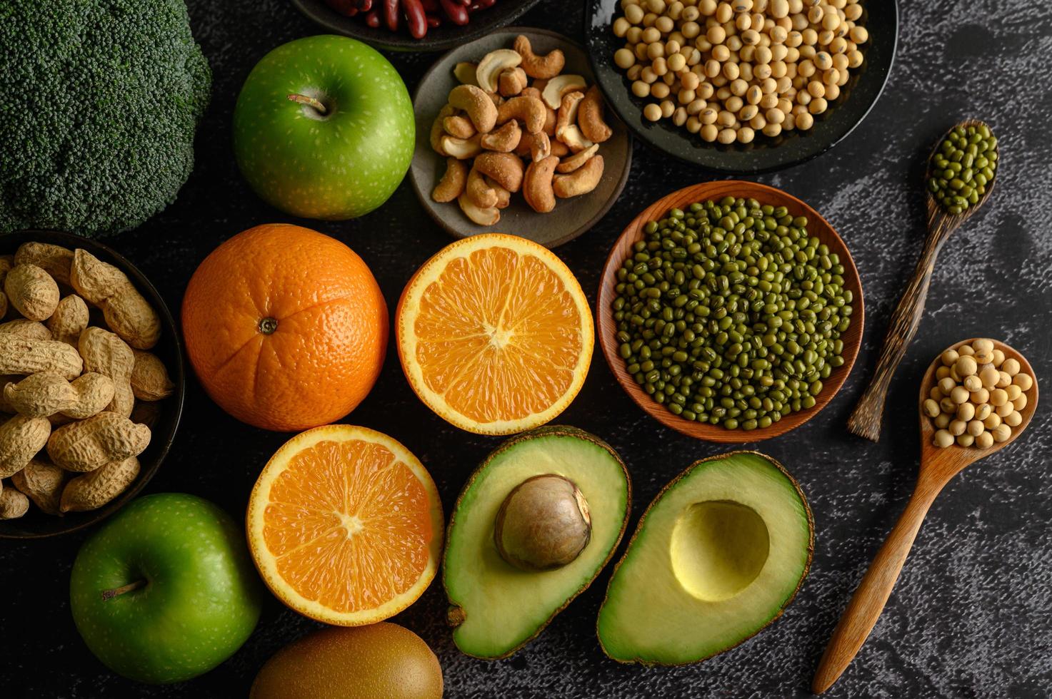 Legumes and fruit on a dark background photo