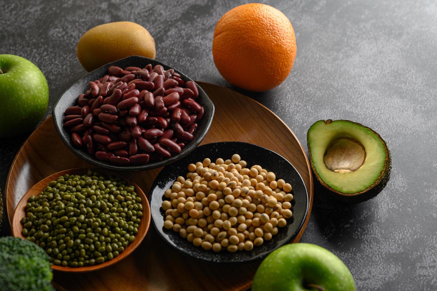 Legumes and fruit on a dark background photo