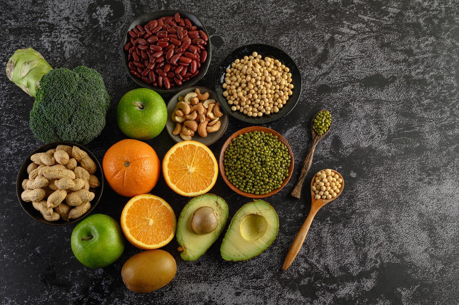 Legumes and fruit on a dark background photo