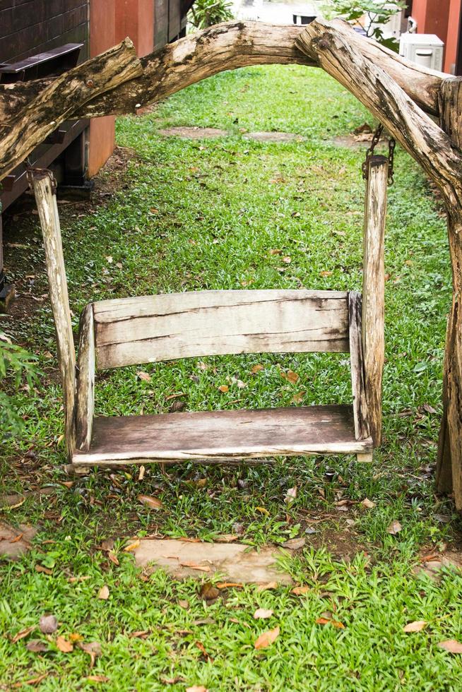 Wooden porch swing in garden photo