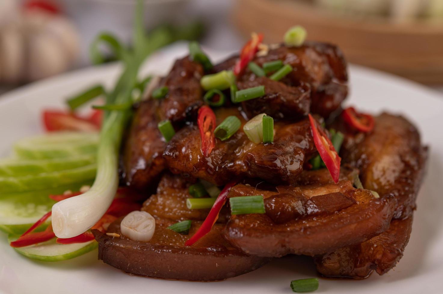 Sweet pork with chopped scallions, chili, lime, cucumber, tomato and garlic photo