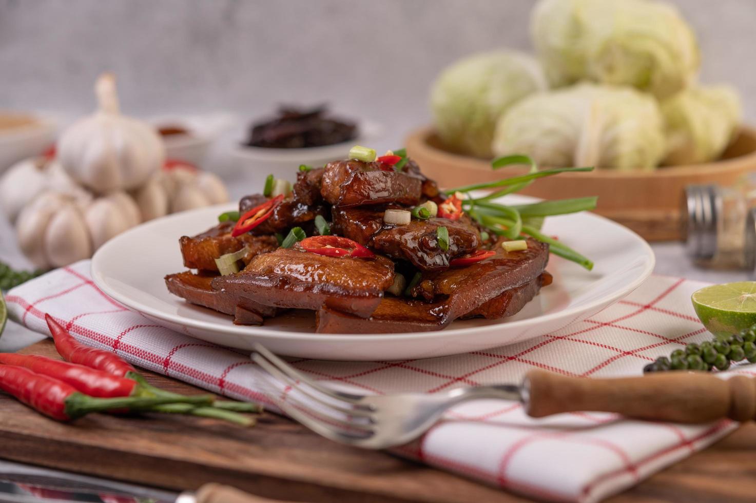 Sweet pork with chopped scallions, chili, lime, cucumber, tomato and garlic photo