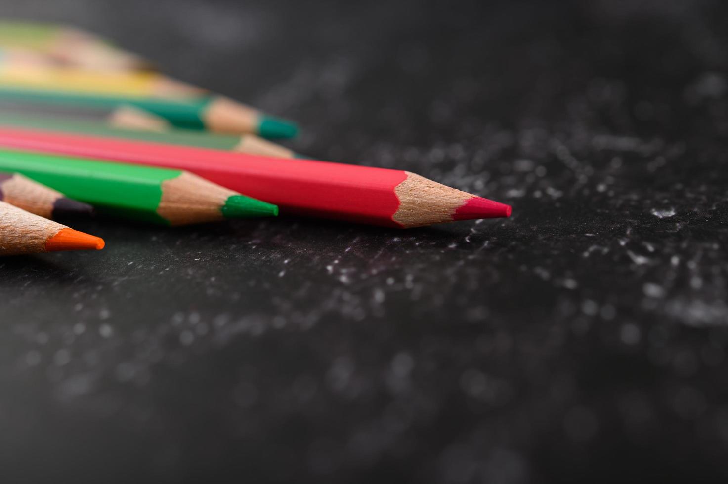 Colorful crayon pencils with triangle shape with copy space photo