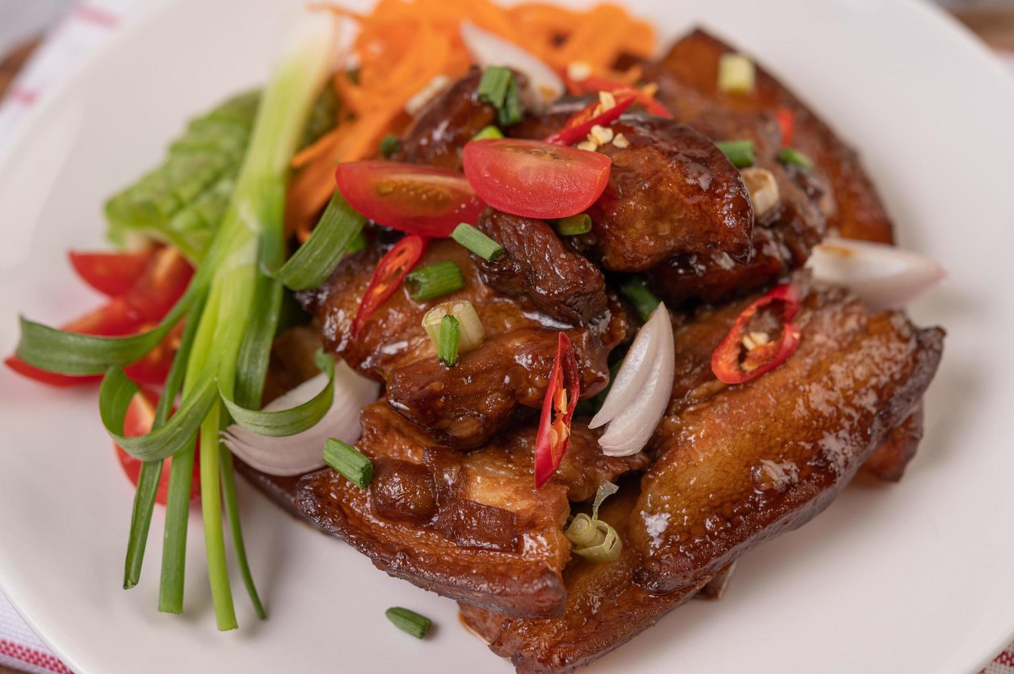 Sweet pork with chopped scallions, chili, lime, gourd, tomato and garlic photo