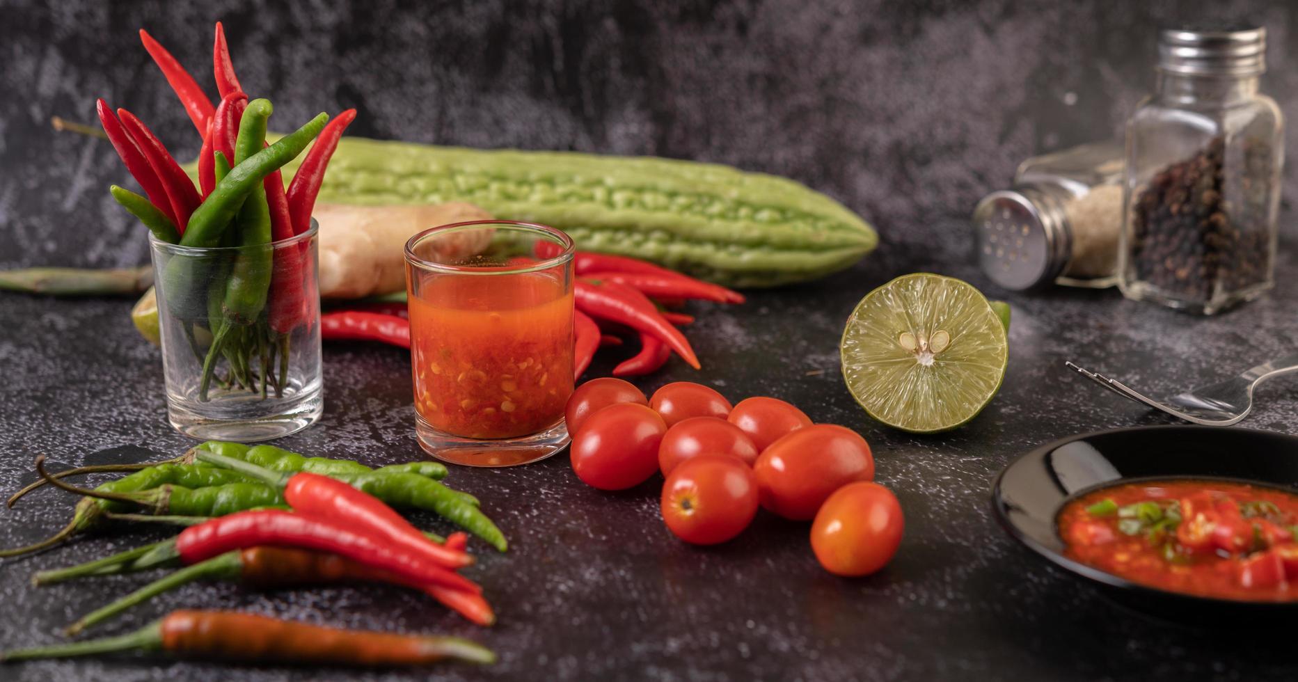 Juice and tomatoes with peppers, lime and bitter gourd photo