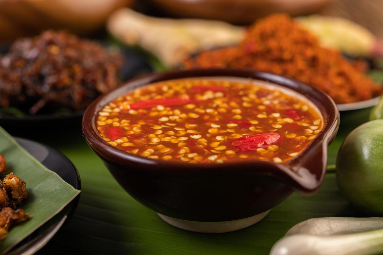 Chili sauce and ingredients on banana leaves photo