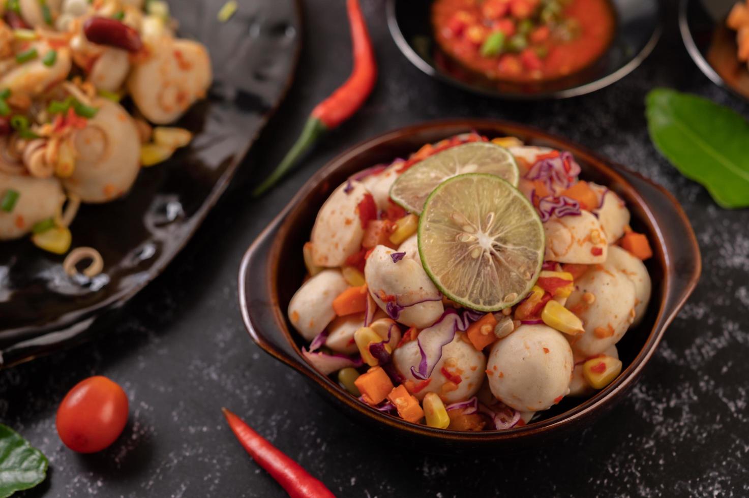 Spicy meatball salad with chili, lemon, garlic and tomato photo