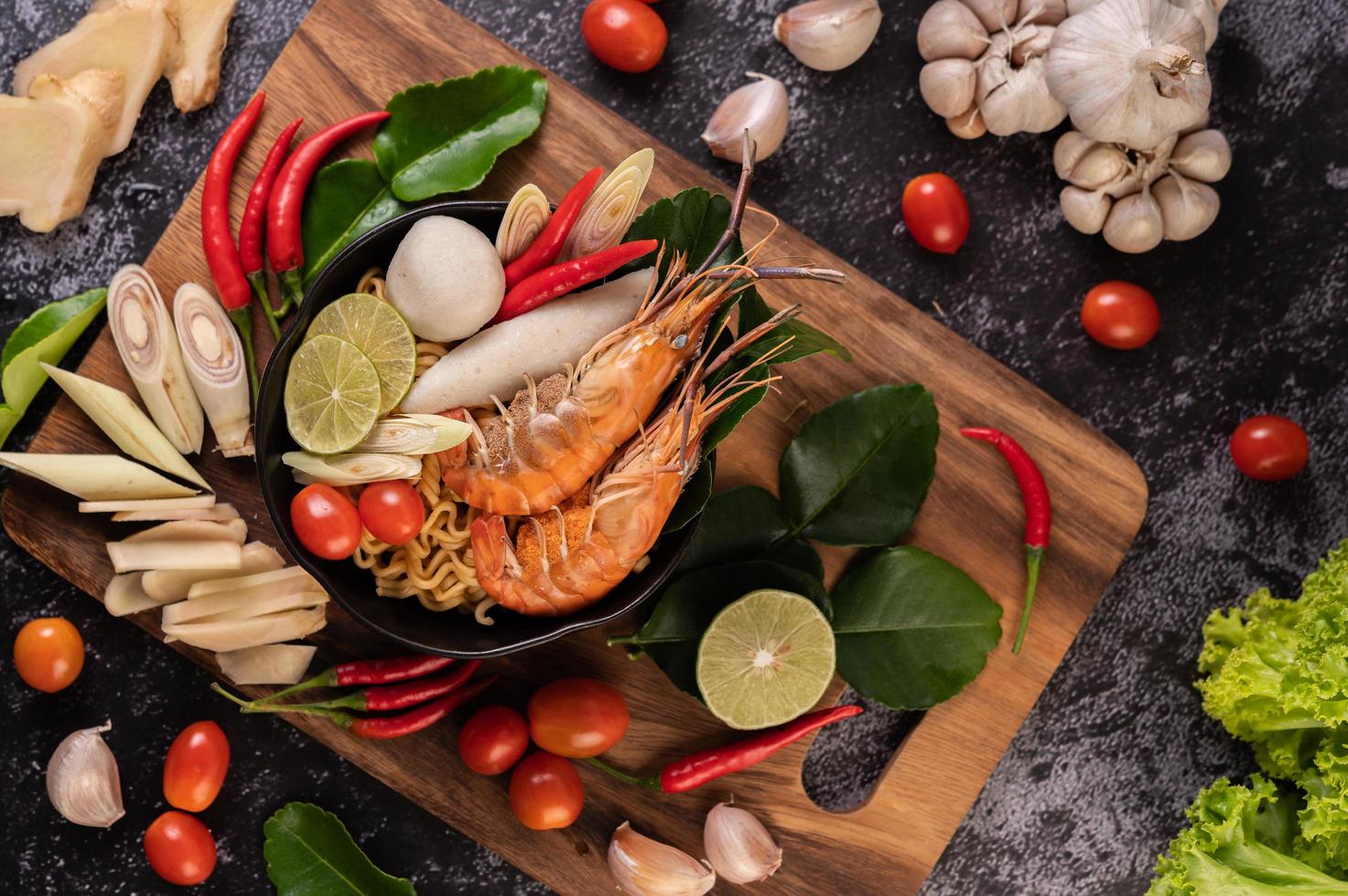 Tom Yum Kung soup with tomato, chili, lemongrass, garlic, lemon, and kaffir photo